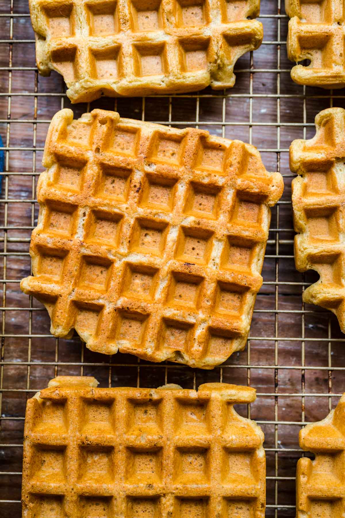 overhead view of vegan waffles on cooling rack. 