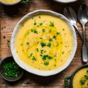 Overhead view of potato leek soup with herb garnish.