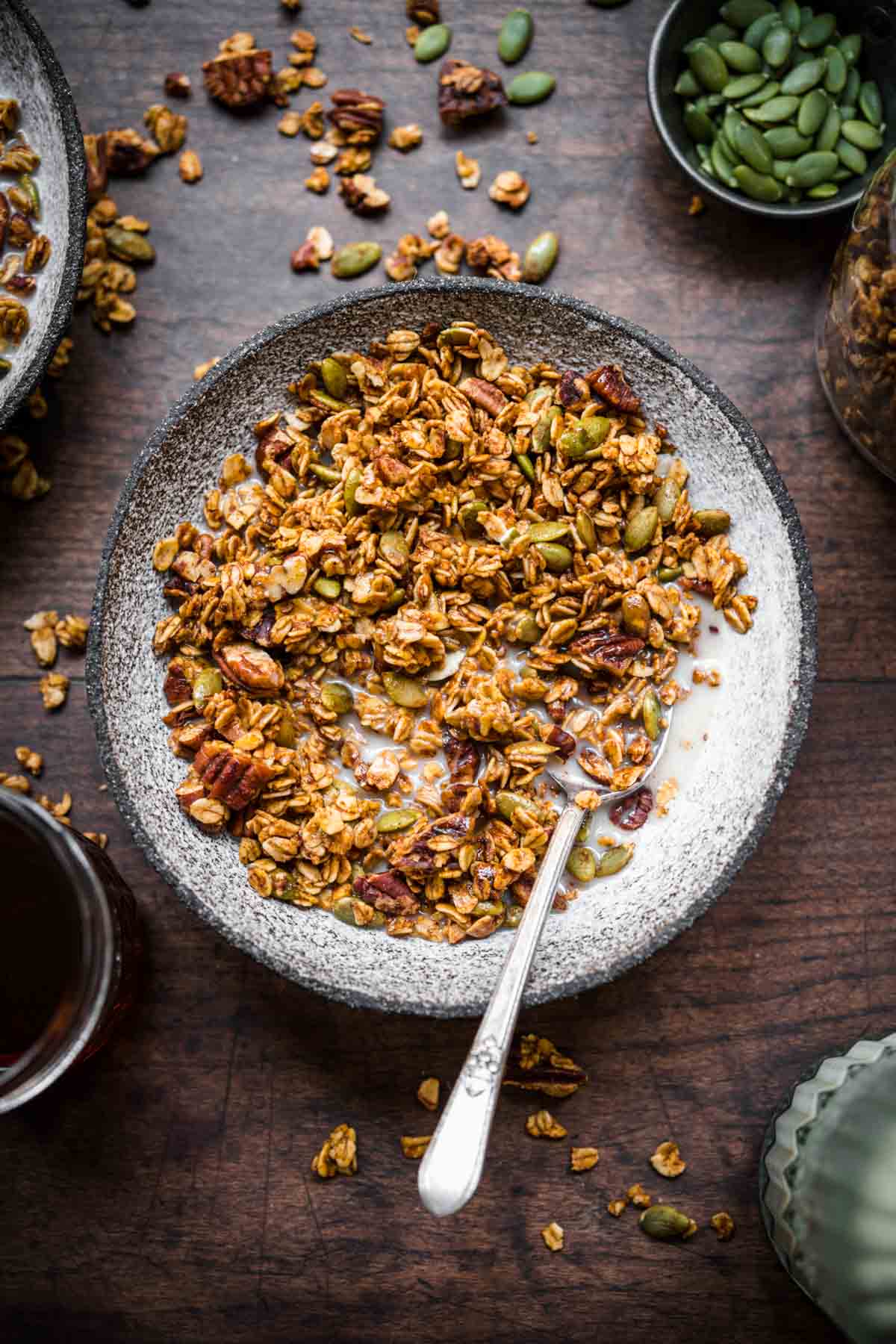 Overhead view of granola in a bowl with milk.