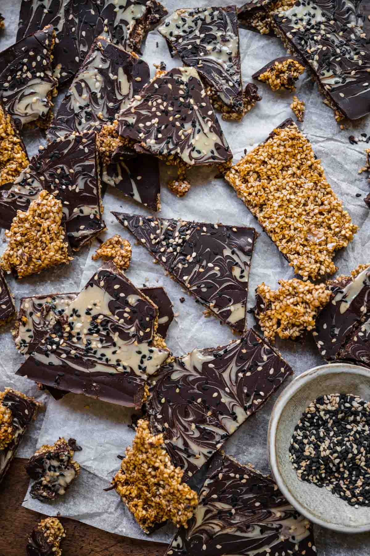 overhead view of sesame chocolate bark broken up into shards. 