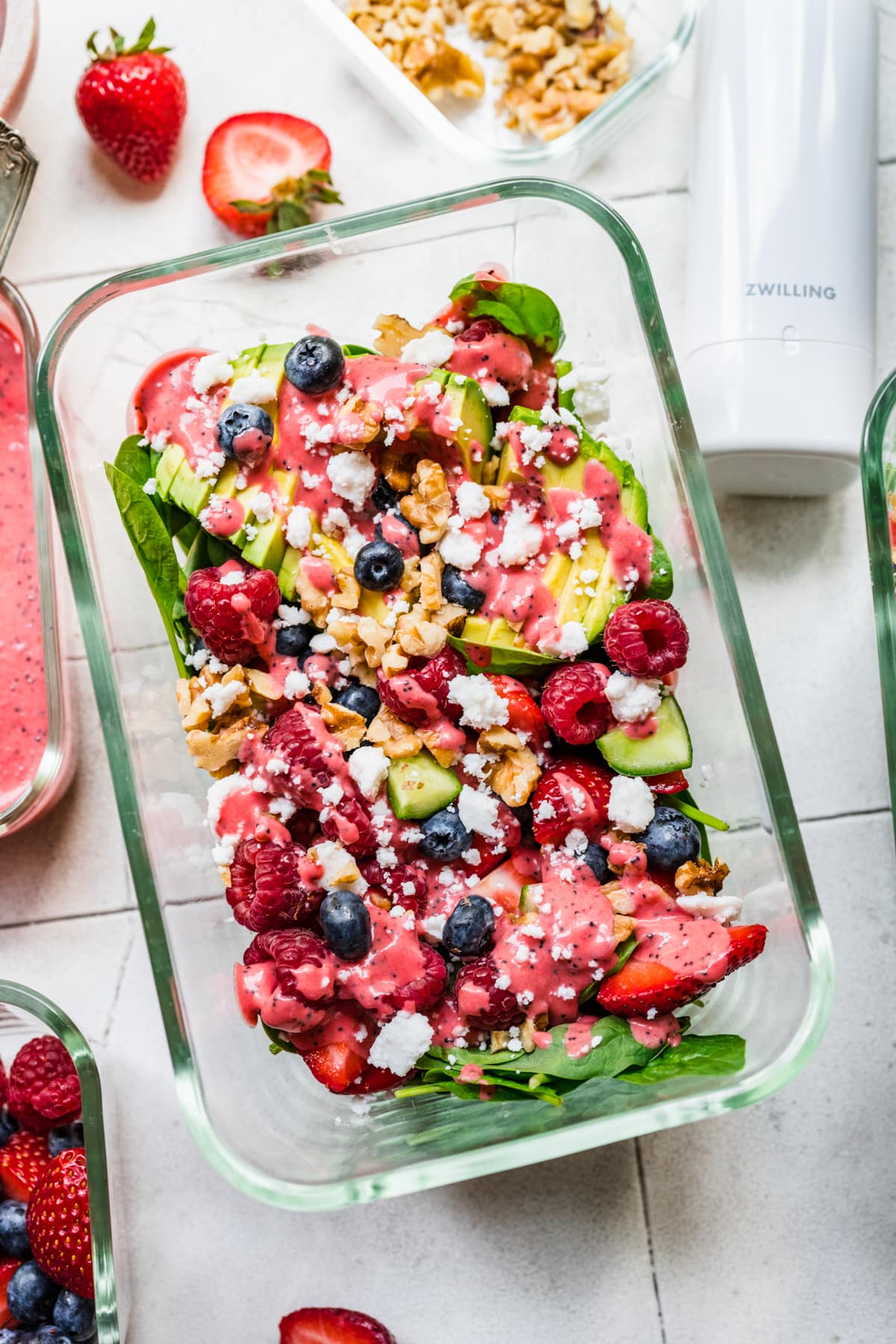 Overhead view of dressed salad in a glass container.