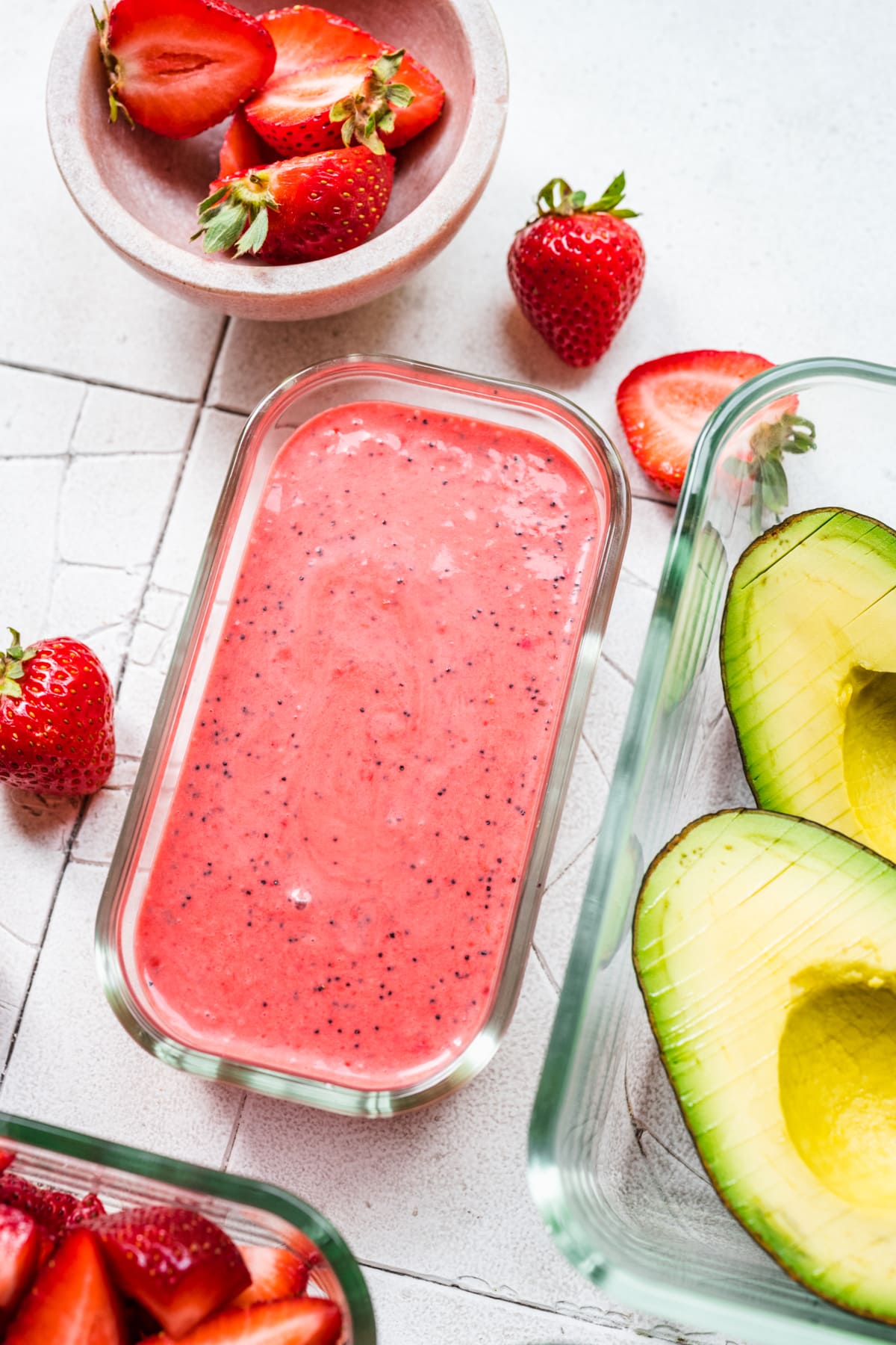 Overhead view of raspberry poppyseed dressing in a small container.