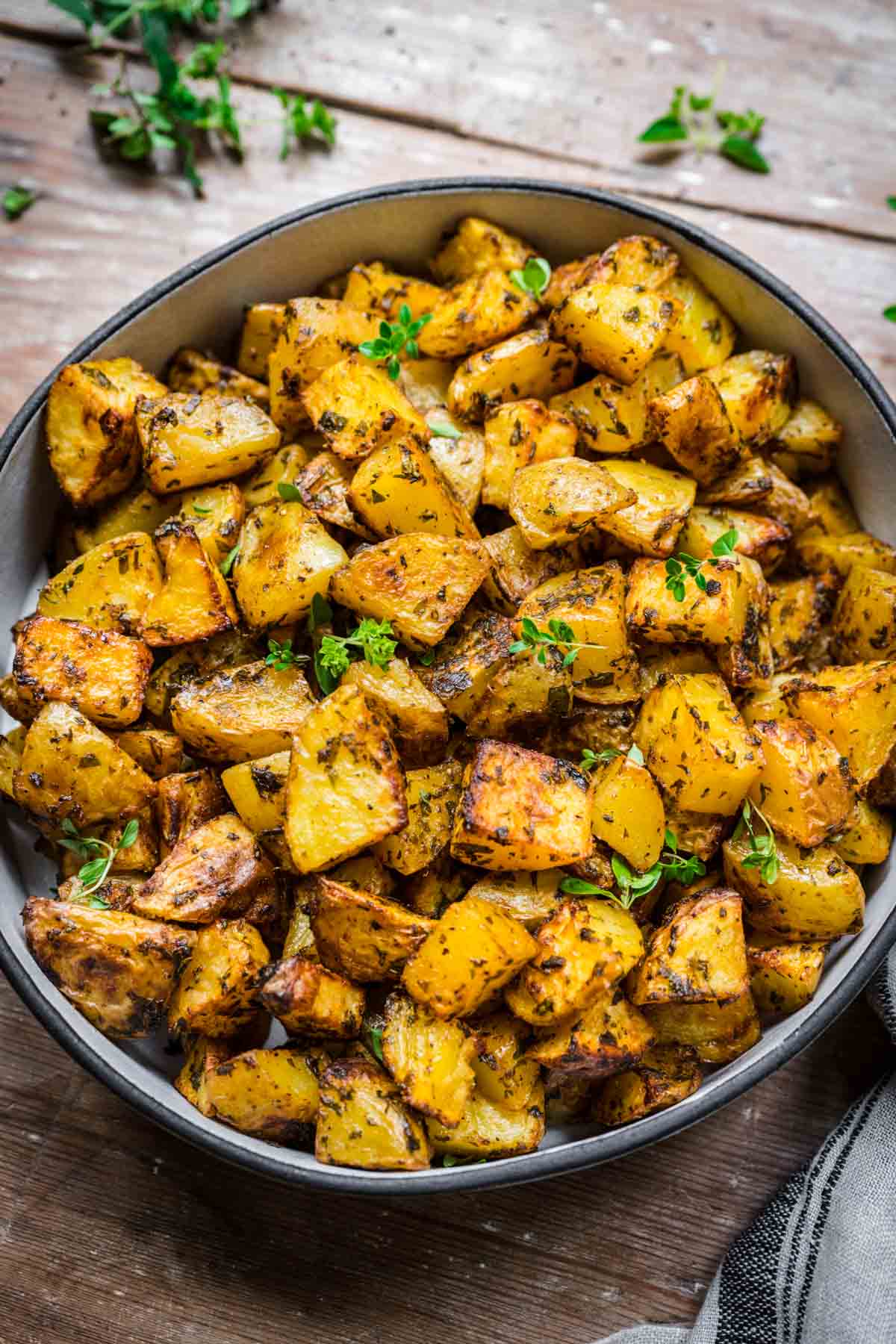 Close up view of roasted potatoes in a bowl.