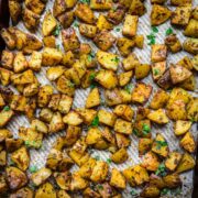 Close up of herb roasted potatoes on a sheet pan.