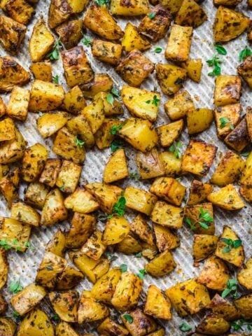 Close up of herb roasted potatoes on a sheet pan.