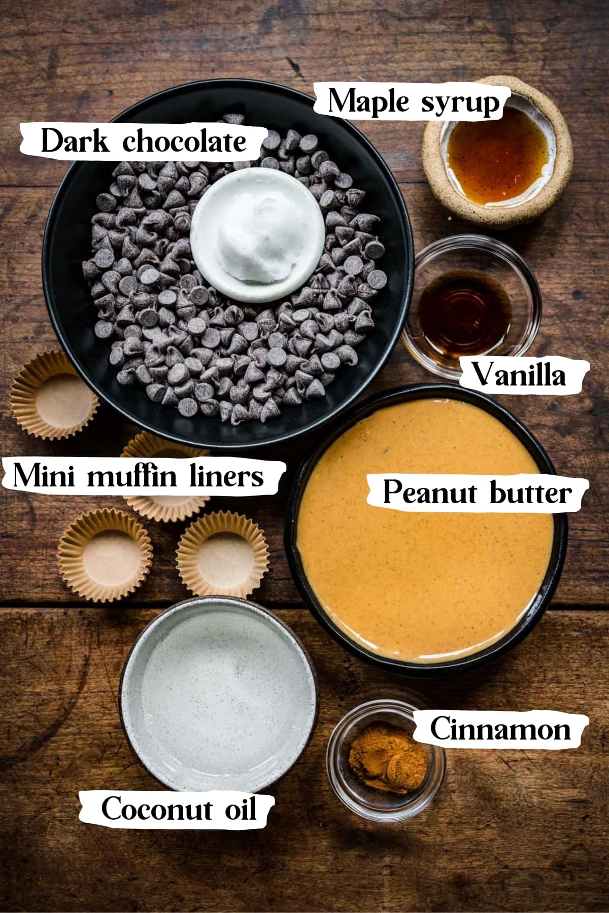 overhead view of ingredients for vegan peanut butter cups in small prep bowls, including chocolate chips and peanut butter.