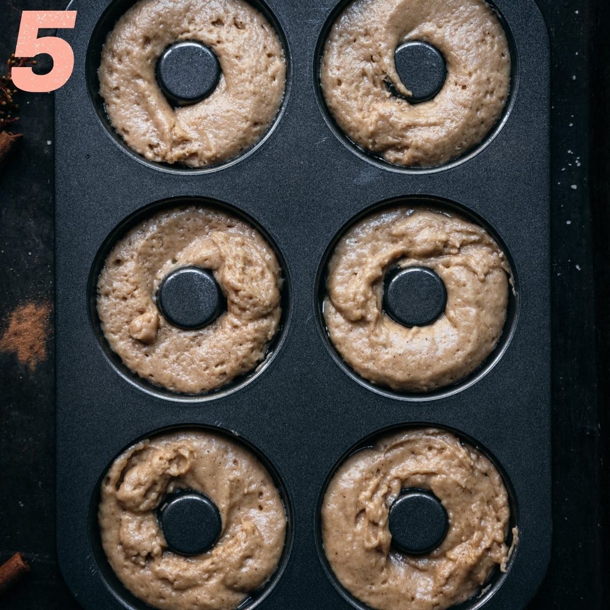 Apple cider donuts after being poured into a donut pan.