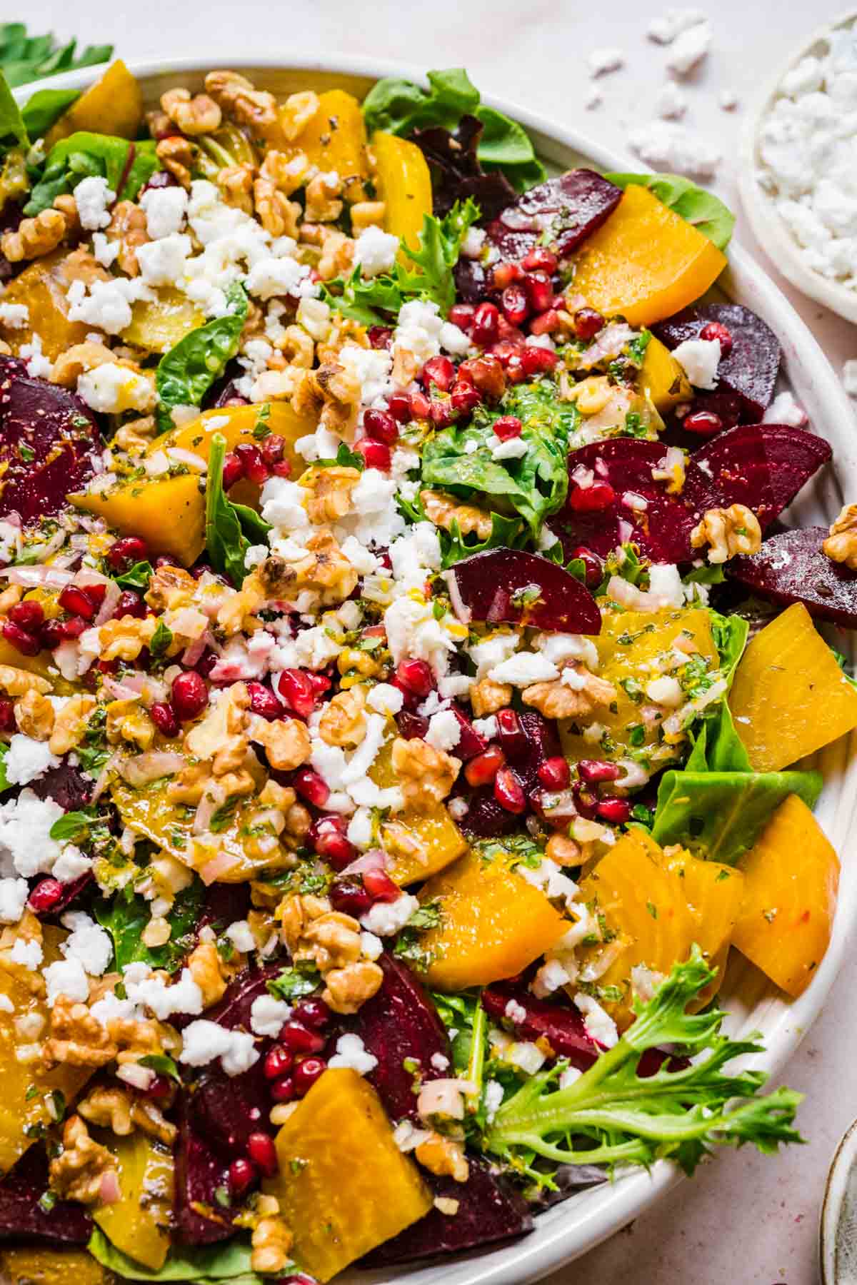 Close up of beet feta salad, showing walnuts, pomegranate, beets, and feta.