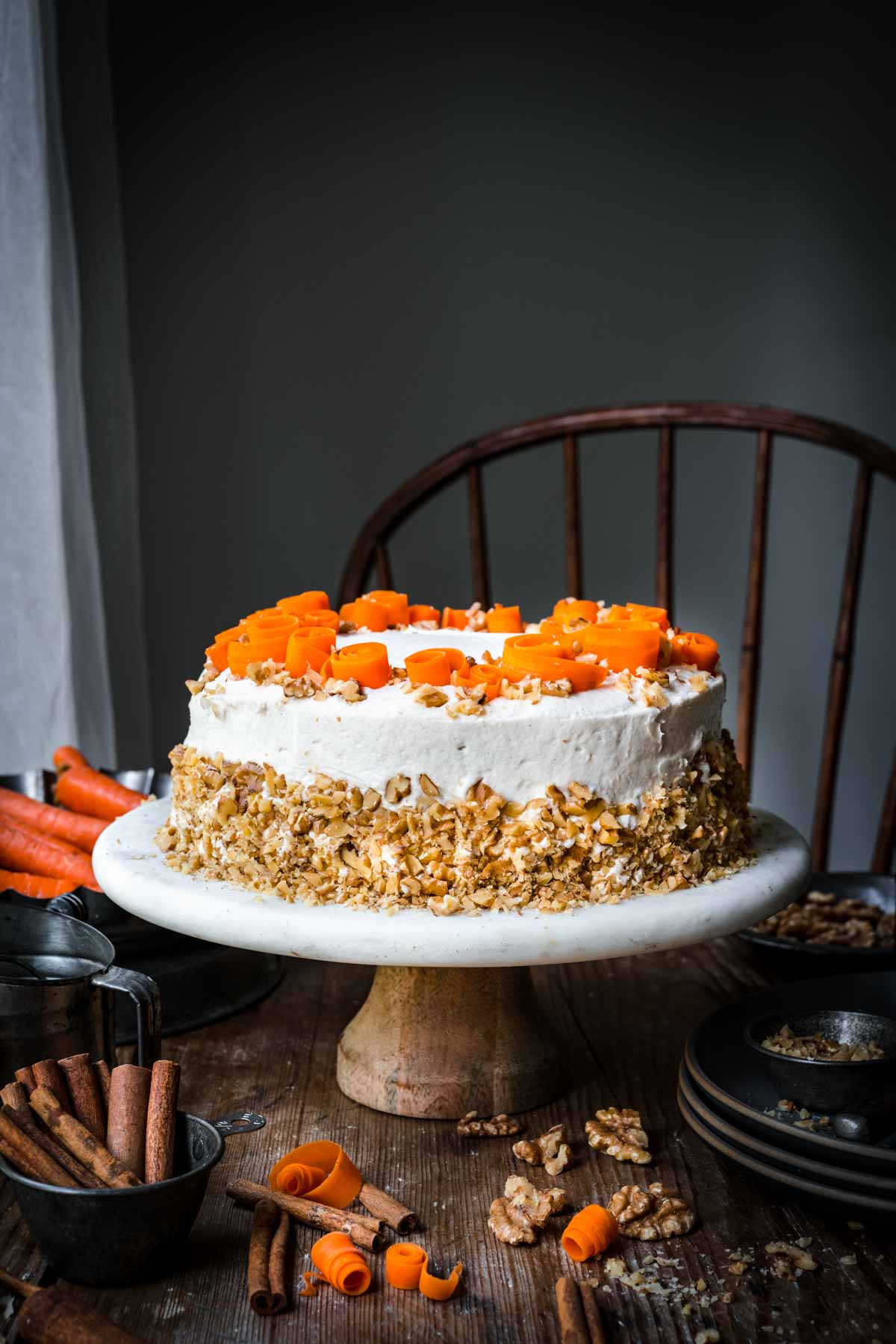 Front view of vegan carrot cake with carrot swirls and crushed walnuts.