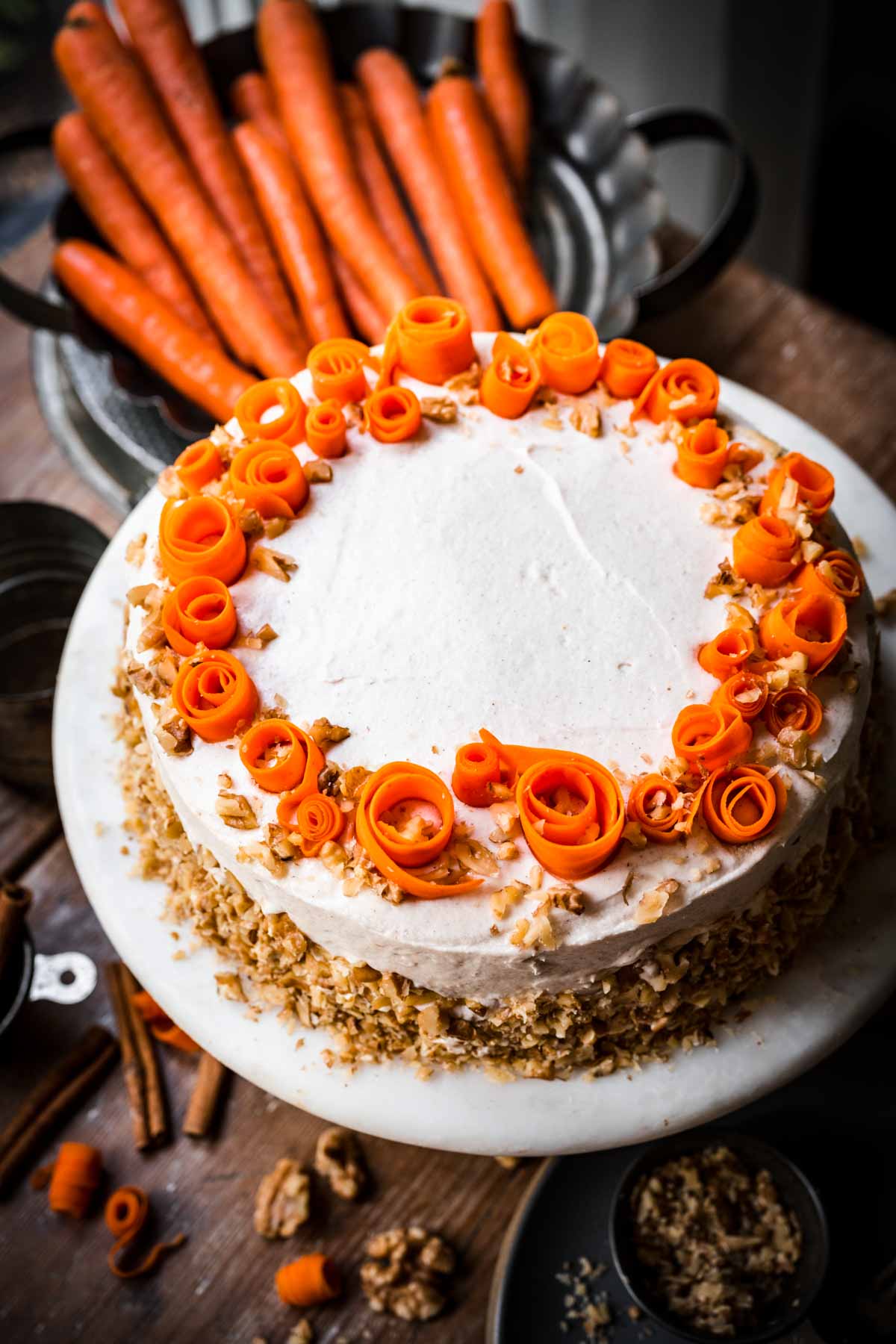 side view of vegan carrot cake on cake stand.