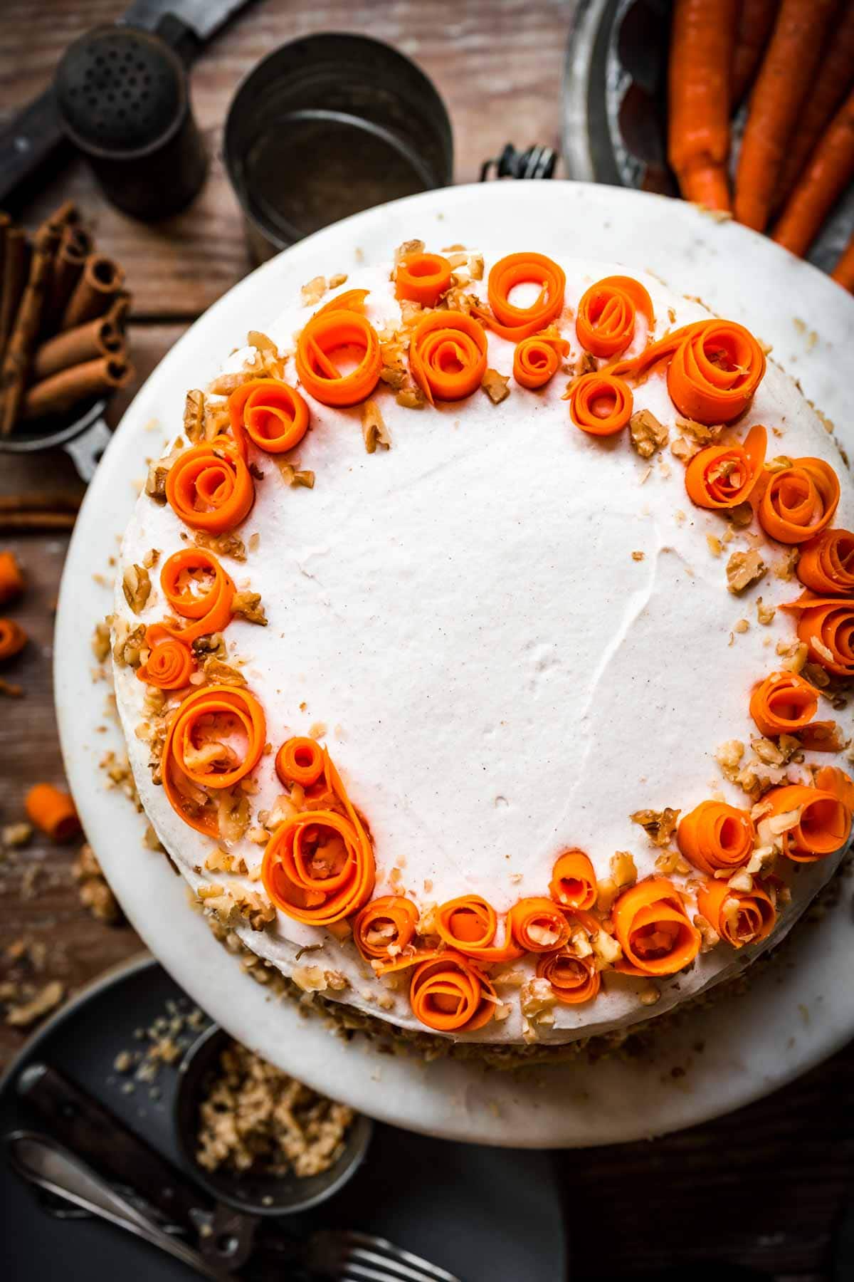 Overhead view of carrot cake on a cake stand.