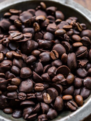 Chocolate covered espresso beans in a bowl.