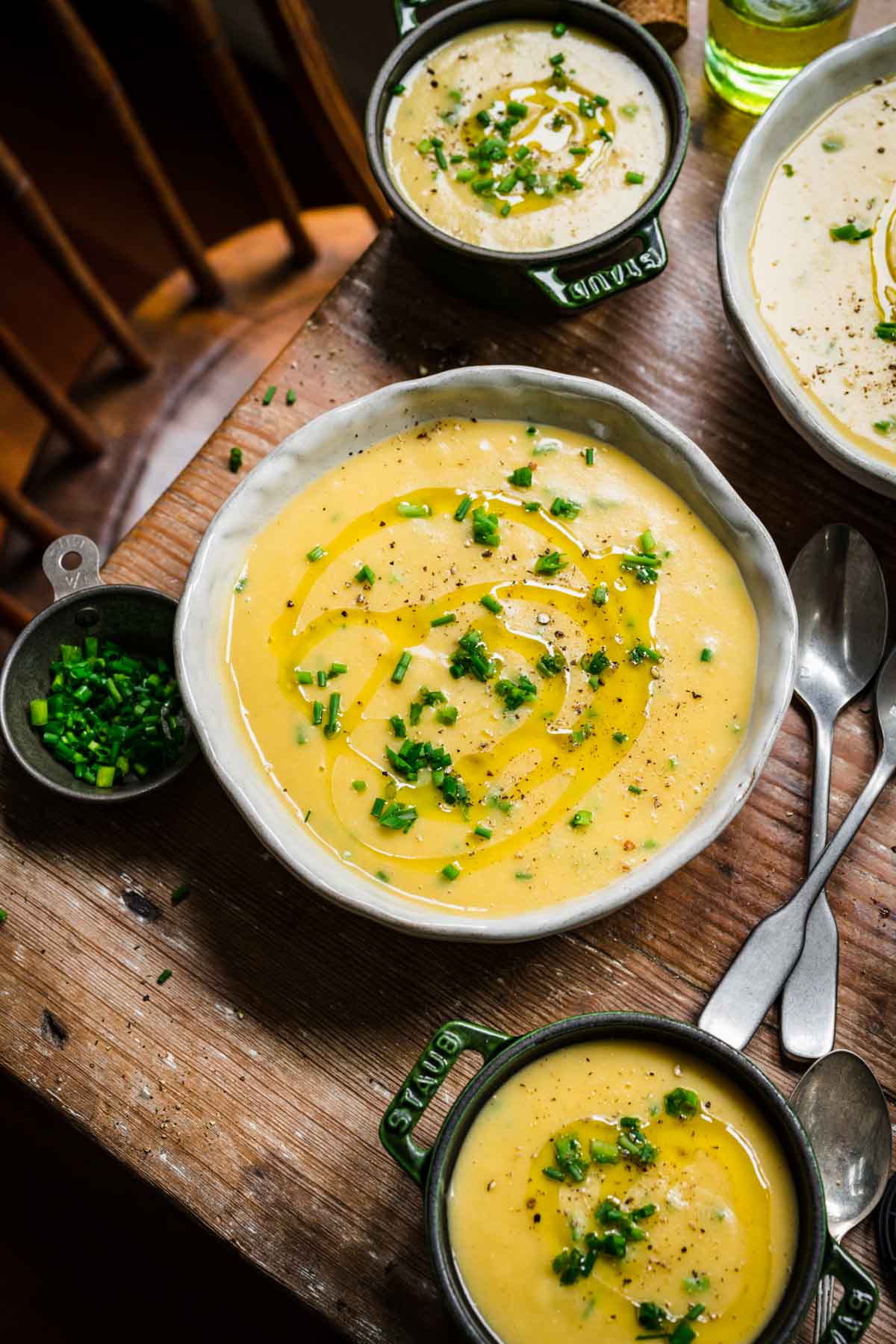vegan potato leek soup in bowl on wood table. 