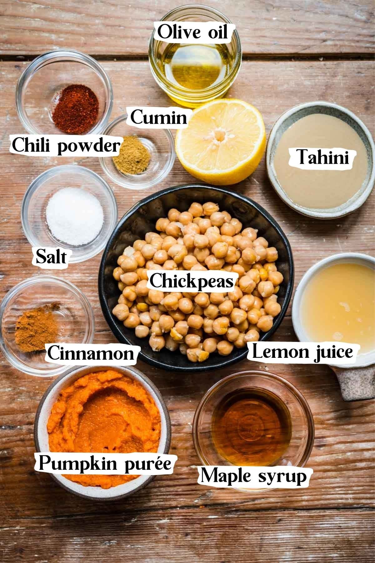 Overhead view of pumpkin hummus ingredients including chickpeas, tahini, and pumpkin puree.