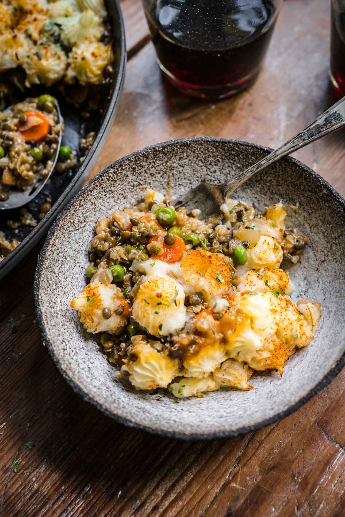 Close up shot of shepherd's pie and mashed potatoes on a plate.