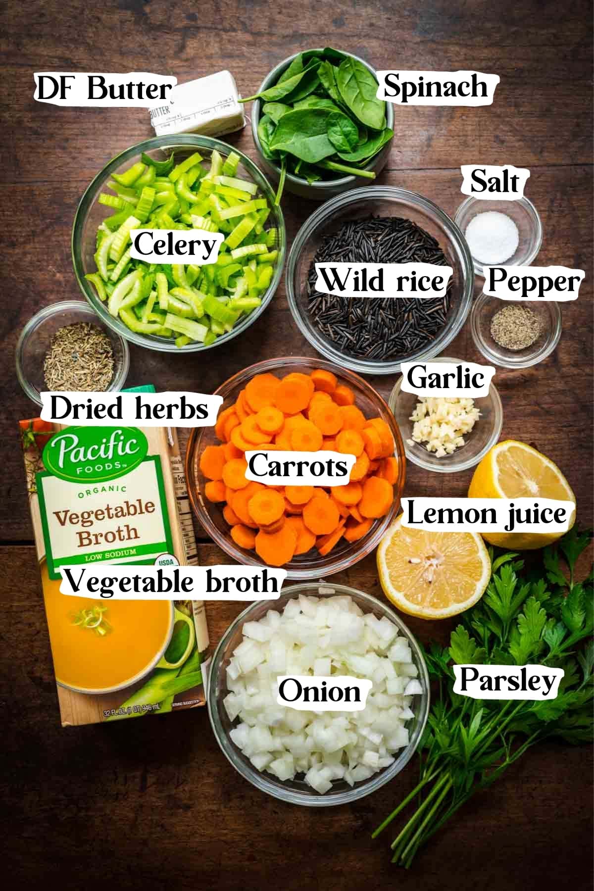 Overhead shot of wild rice soup ingredients, including carrots, celery, onions, and parsley.