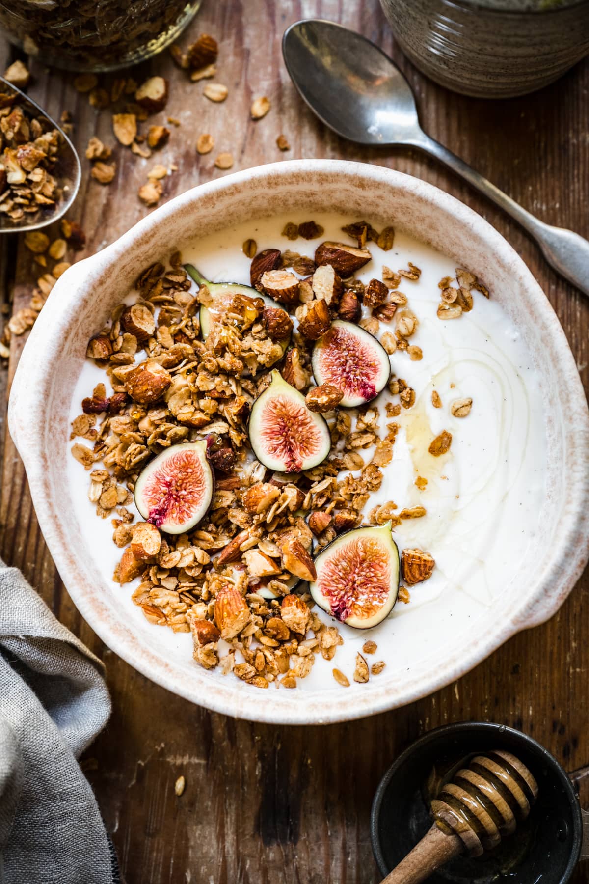 almond granola on top of yogurt with fresh figs and honey. 