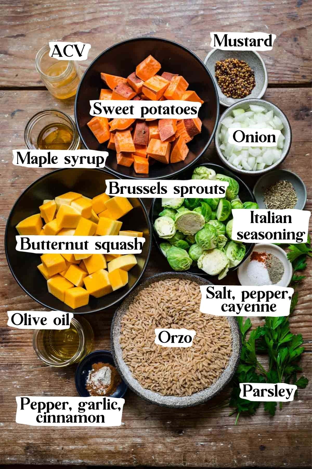 Overhead view of orzo salad ingredients, including sweet potatoes, brussels sprouts, butternut squash, and orzo.