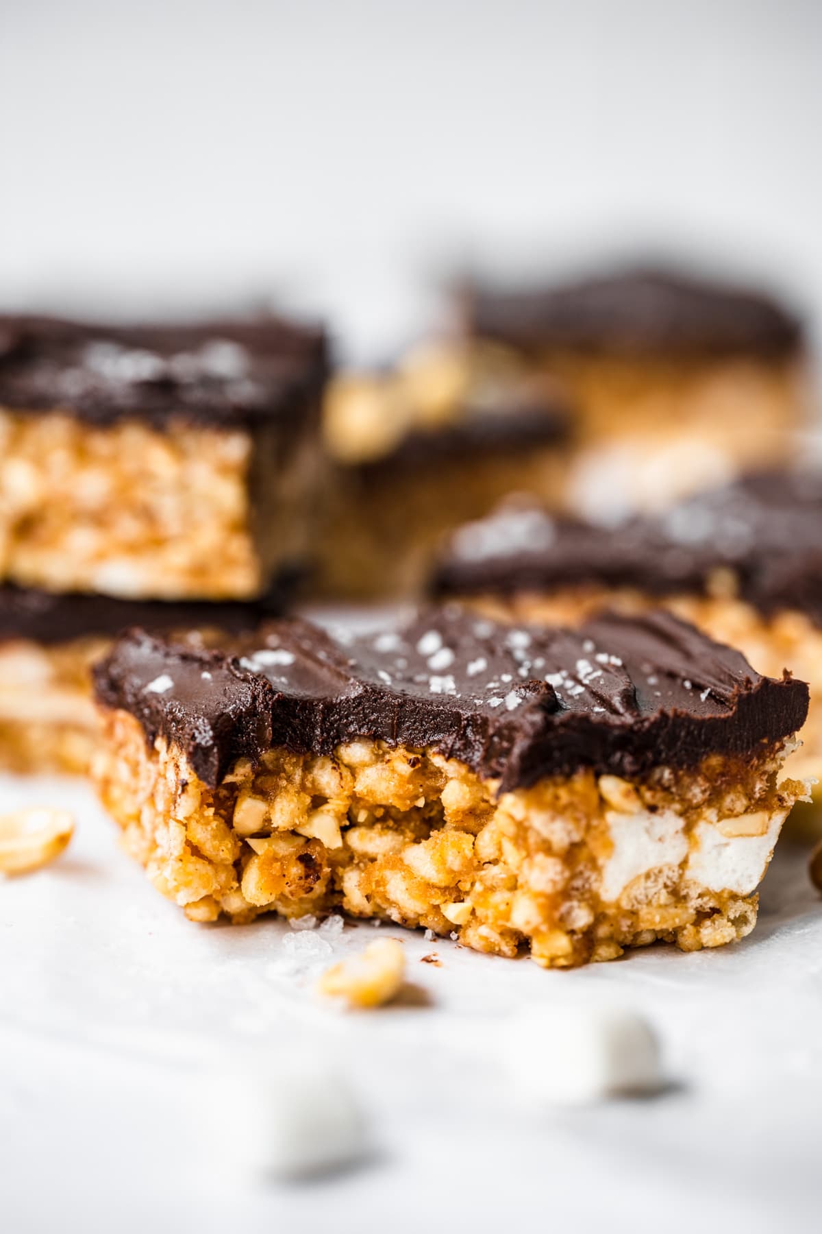 Front view of a rice krispie treat with a bite taken out of it.