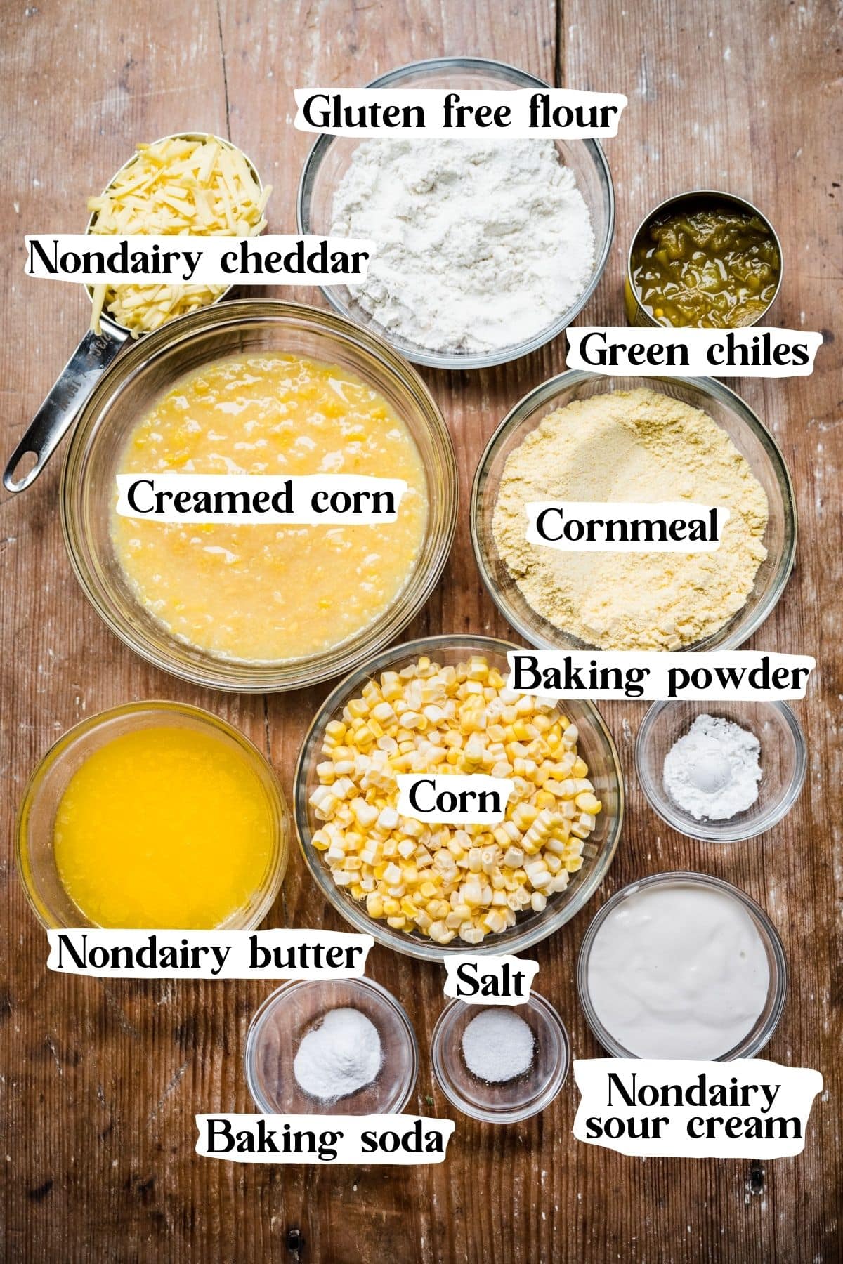 Overhead view of vegan corn casserole ingredients, including cornmeal and creamed corn.