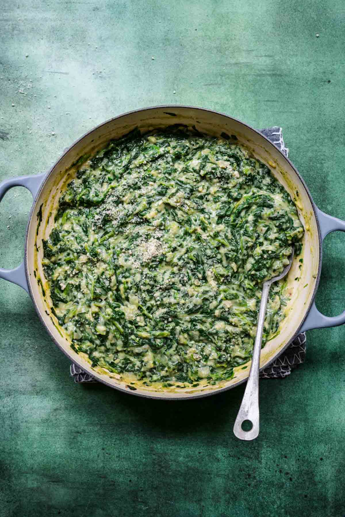 Overhead view of creamed spinach in a dutch oven.