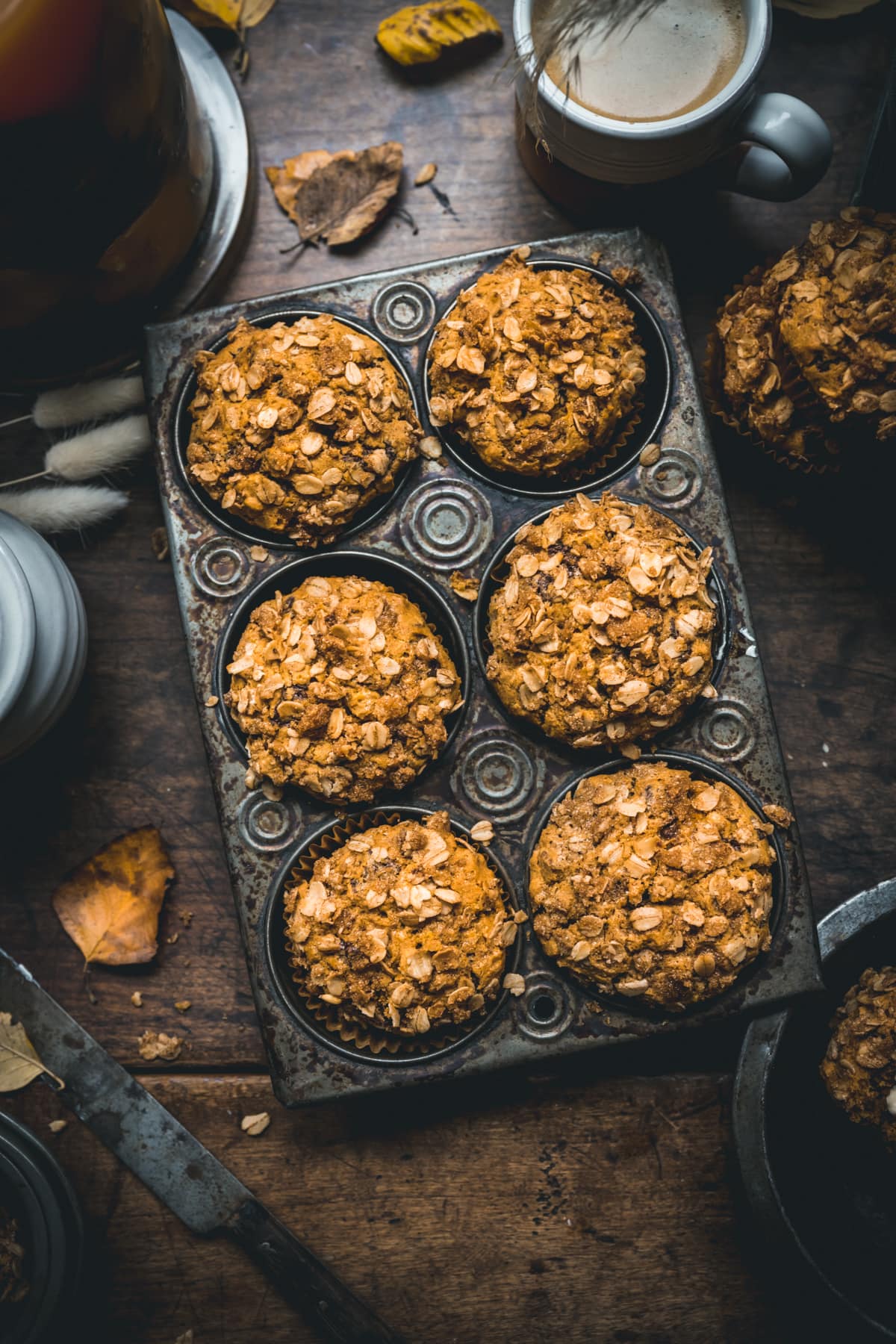 Overhead view of 6 pumpkin muffins in a muffin tin.