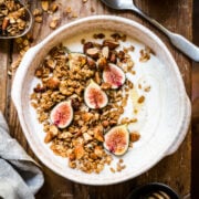 almond granola on top of yogurt with fresh figs and honey.