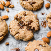 close up view of chocolate chip almond flour cookie broken in half with melted chocolate showing.