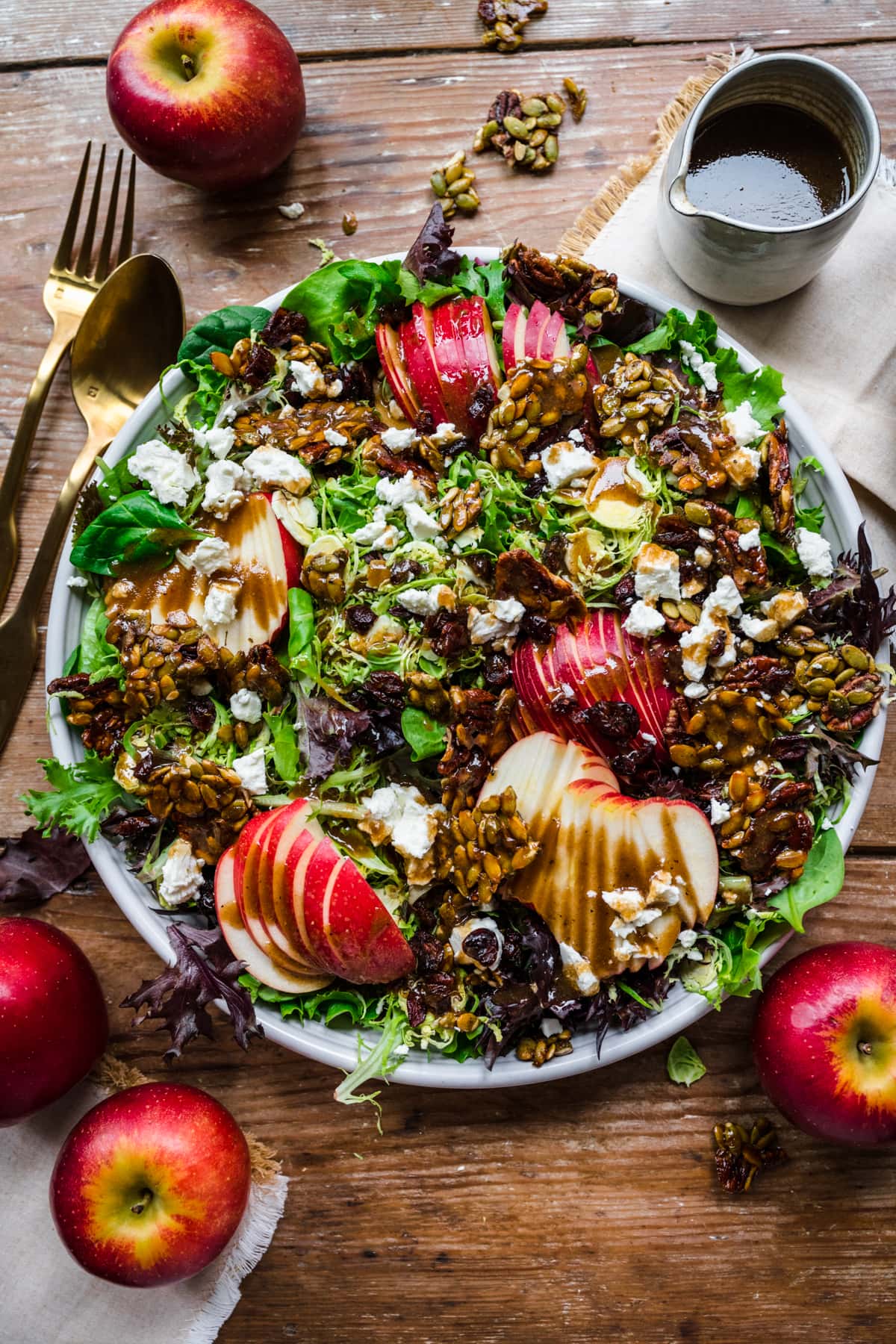Overhead view of apple salad with dressing drizzled over the top.