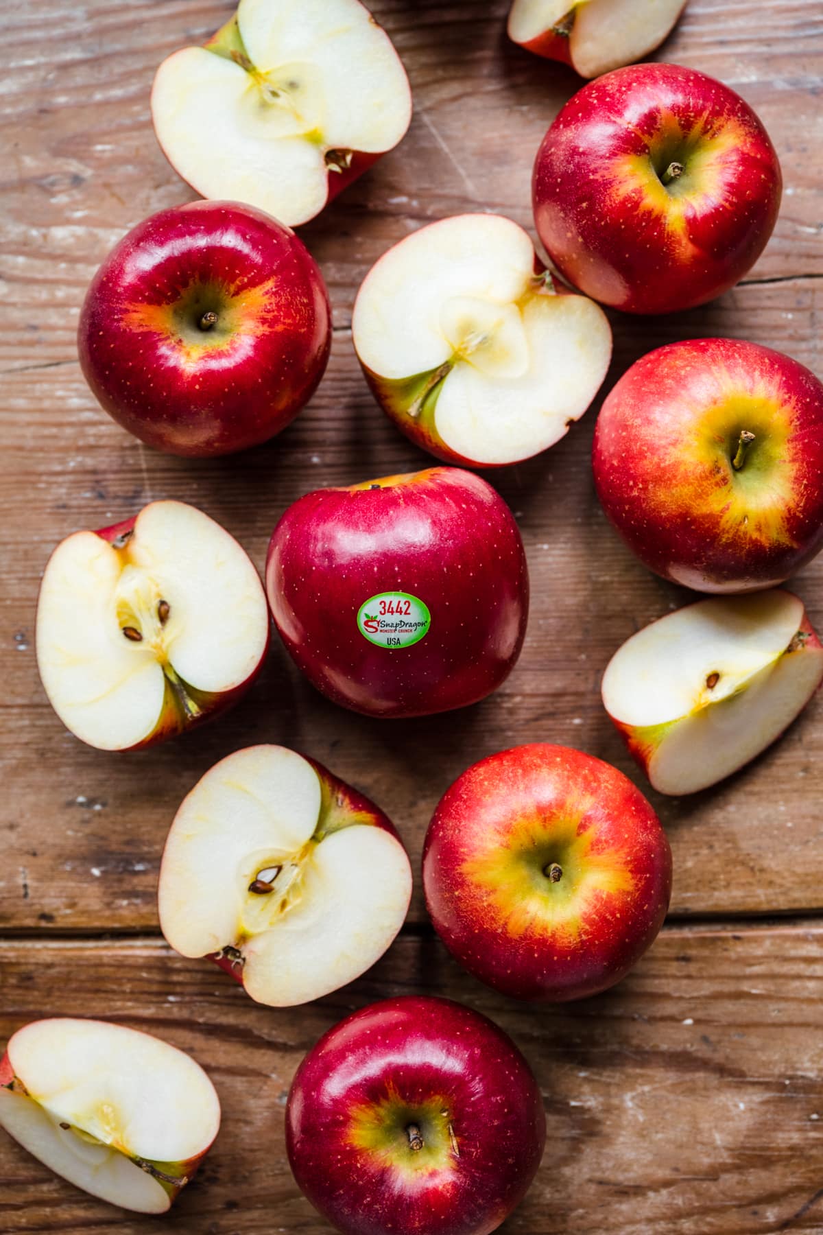 Overhead view of SnapDragon apples on a wooden background.