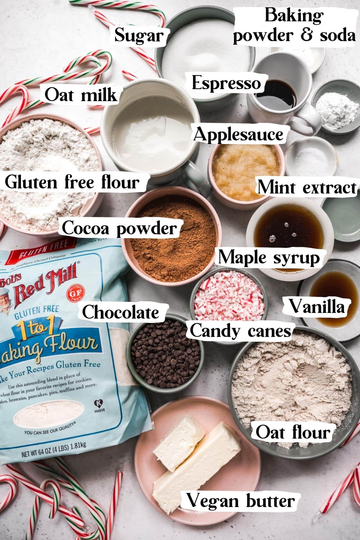 Overhead shot of chocolate peppermint cake ingredients, including sugar, cocoa powder, and candy canes.