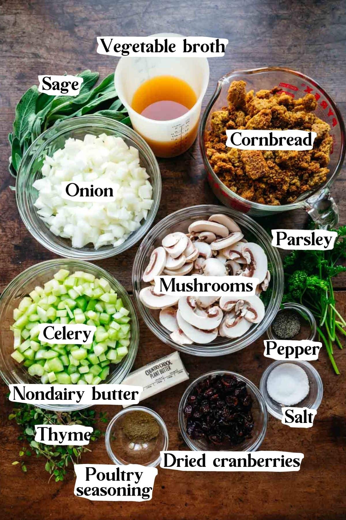 Overhead view of cornbread stuffing ingredients, including vegetable broth, onion, spices, and cornbread.