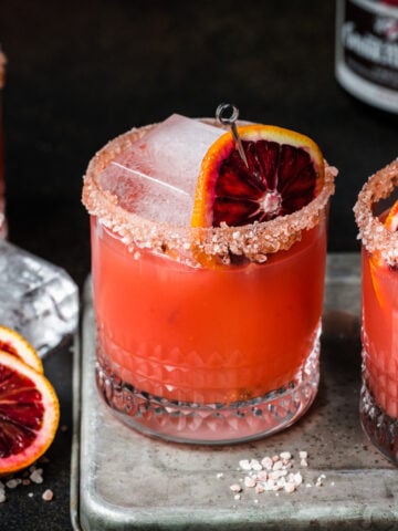 Front view of a grand marnier margarita garnished with a blood orange slice.