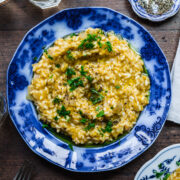 Overhead view of vegan risotto in a blue bowl.