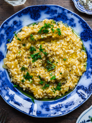 Overhead view of vegan risotto in a blue bowl.