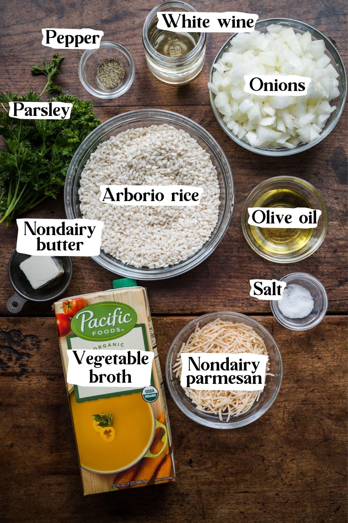 Overhead view of vegan risotto ingredients, including arborio rice, white wine and onions.
