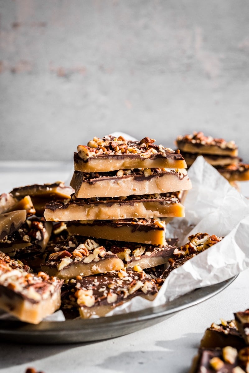 Stack of homemade vegan toffee with white background.