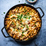 Overhead view of pasta al forno in a round cast iron pan.