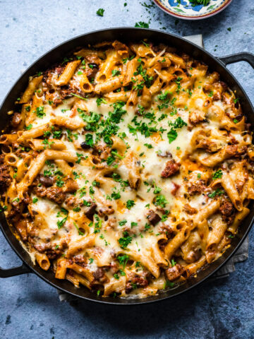 Overhead view of pasta al forno in a round cast iron pan.