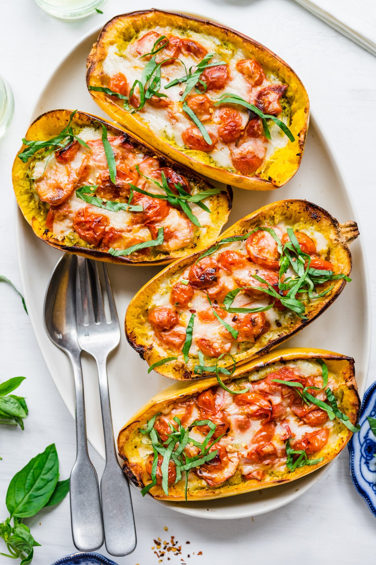 Overhead view of platter of pesto caprese spaghetti squash.