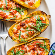 Overhead view of platter of pesto caprese spaghetti squash.