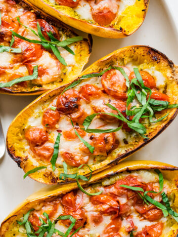 Overhead view of platter of pesto caprese spaghetti squash.