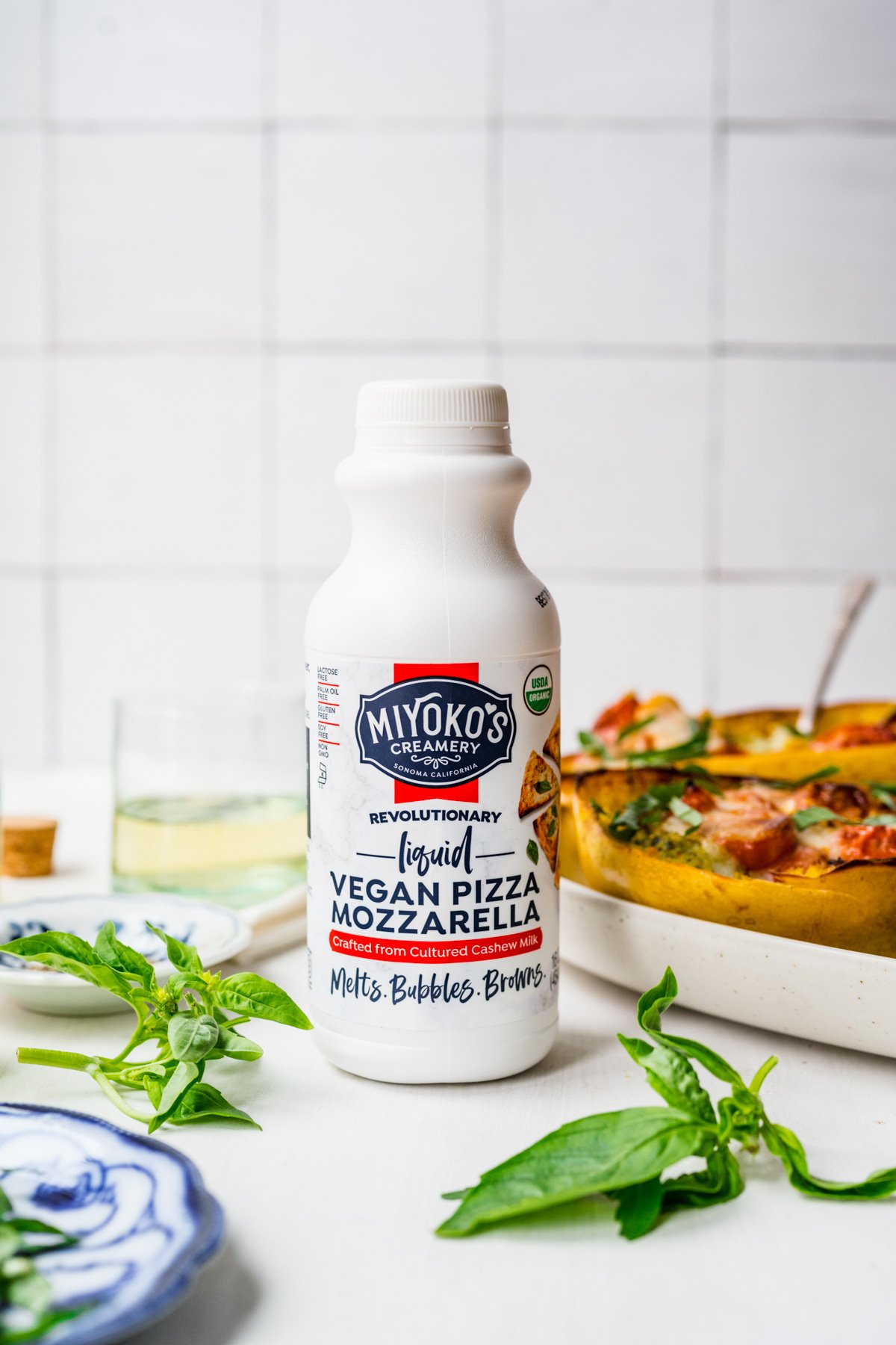 side view of Miyoko's Liquid vegan pizza mozzarella bottle. 