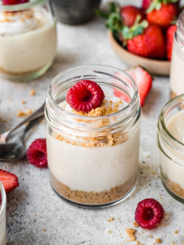 Overhead view of raspberry cheesecake in a jar.