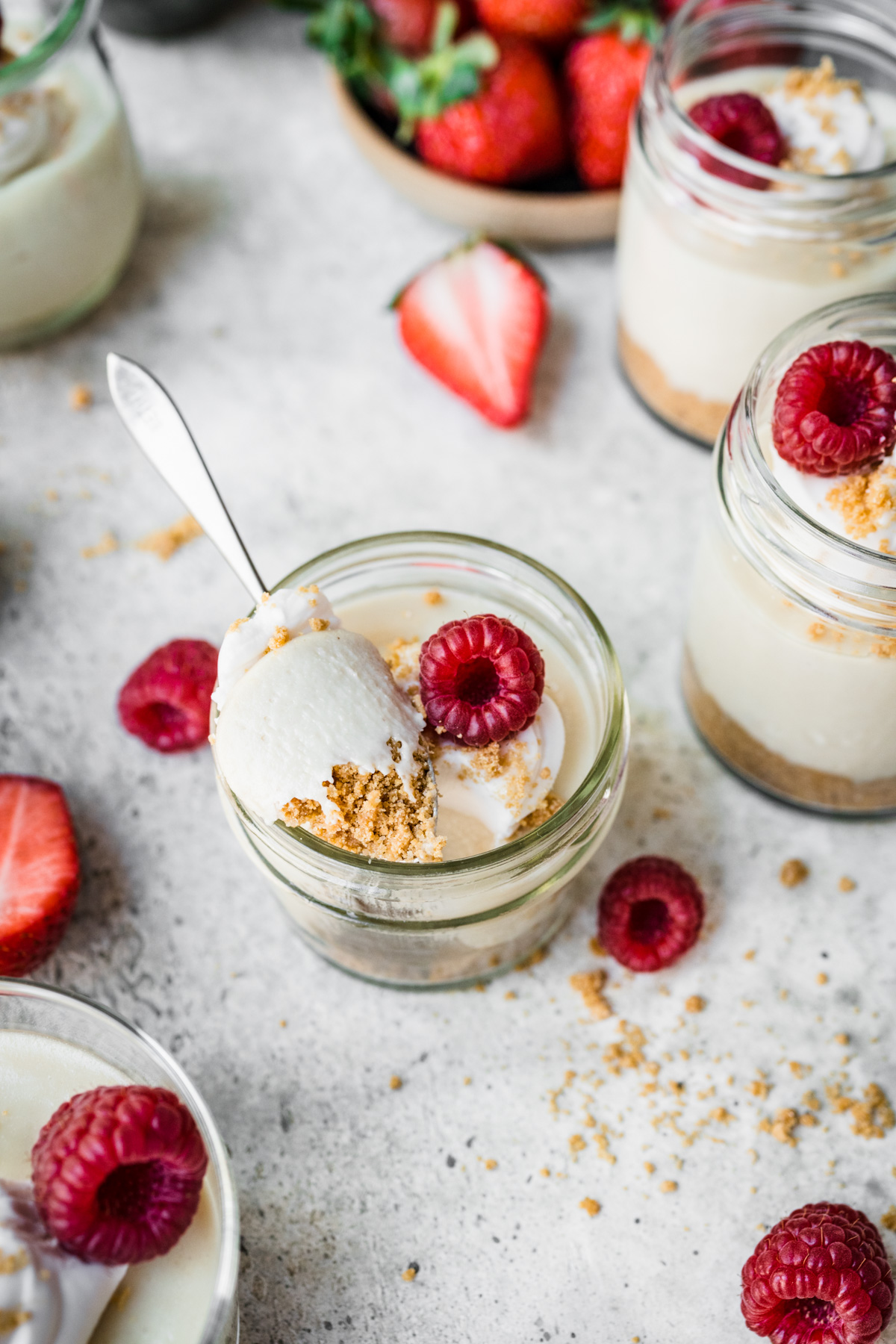 Close up view of spoonful of vegan cheesecake in a jar. 