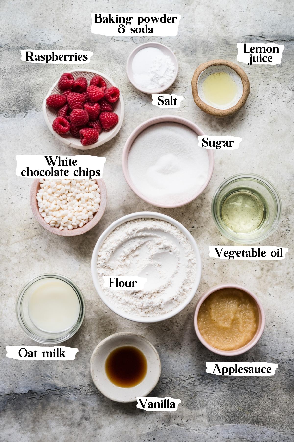 Overhead view of raspberry muffin ingredients, including raspberries and sugar.