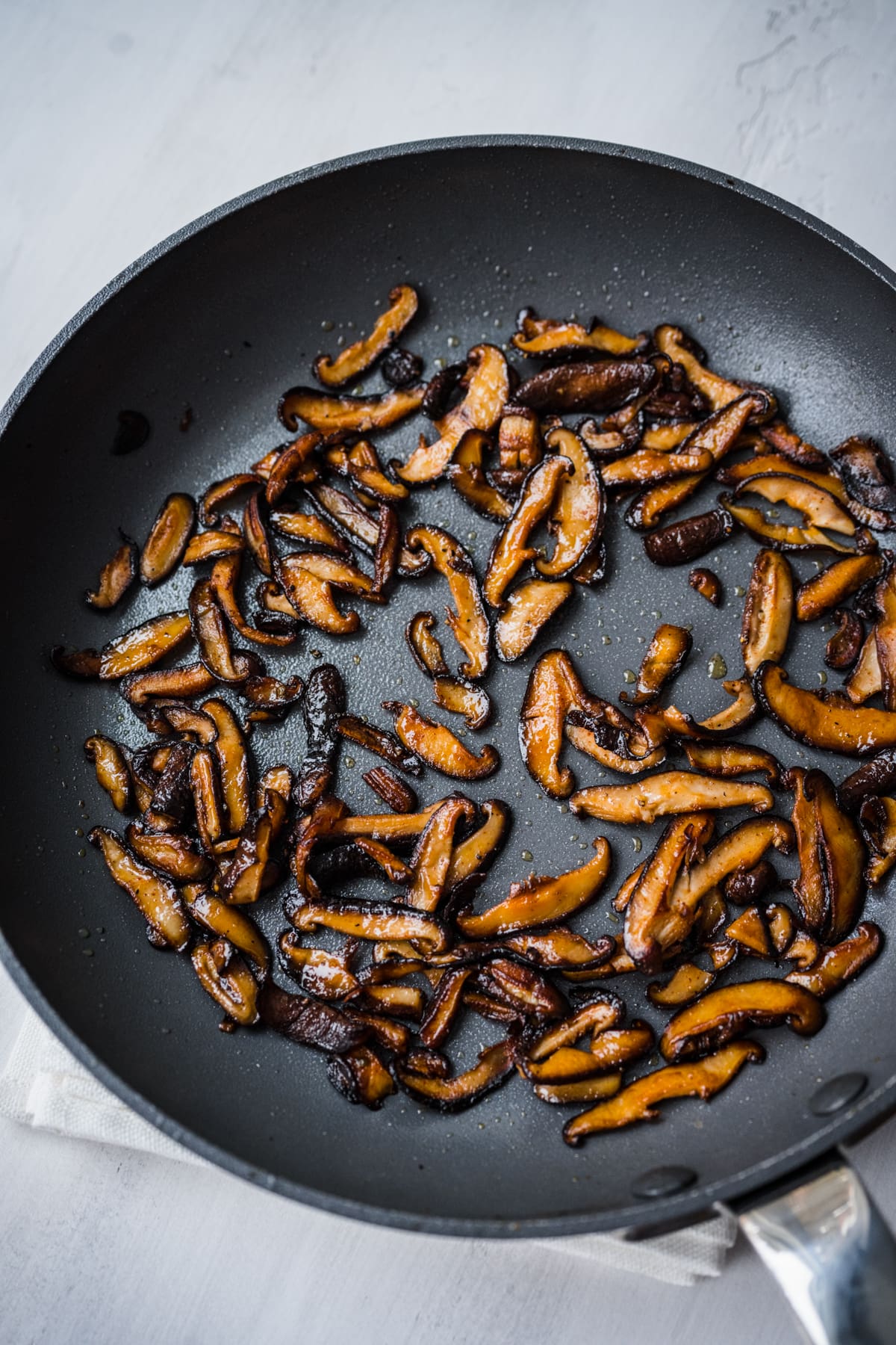 Overhead view of mushroom bacon in a pan.