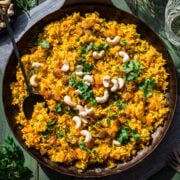 Overhead view of carrot rice in a pan.