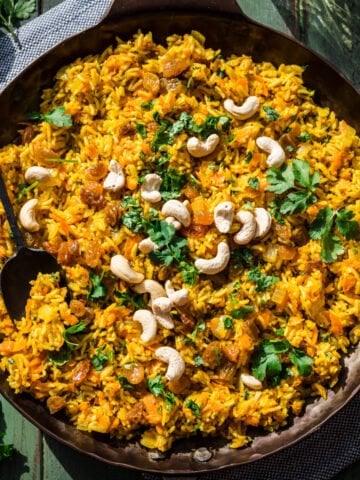 Overhead view of carrot rice in a pan.