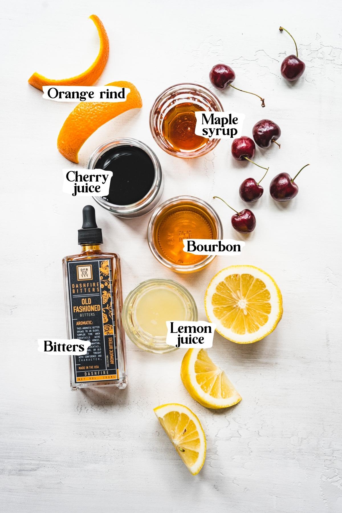 Overhead view of cherry old fashioned ingredients, including lemon juice and bourbon.